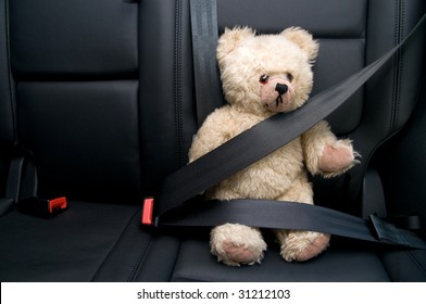 Teddy Bear Buckled With Safety Belt In A Car