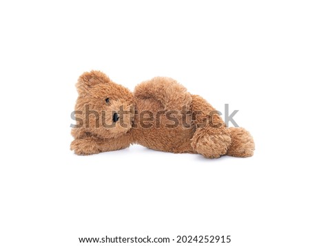 Teddy bear doll with one eye left lying on the floor isolated on white background.