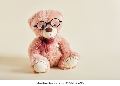 Teddy Bear With Eye Glasses On Beige Background Children's Glasses, Glasses For Children, Training Concept, Optics Shop