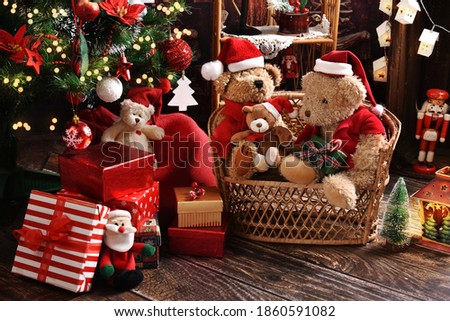 teddy bear family sitting at home by the Christmas tree at holiday time