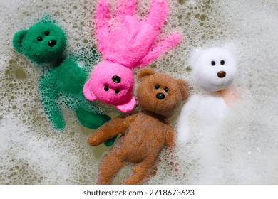 Teddy bear floating in soapy bubble water.