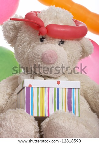 teddy bear with gift box over the balloons