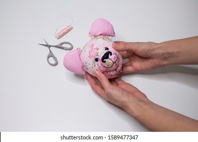 Teddy Bear Head Sewing Process. The process of hand sewing with fabric, scissors, accessories for sewing. Hands sew a toy