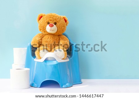 Teddy bear on a children's pot; the concept accustom the child to the potty