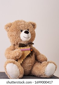 Teddy bear playing the Pan flute
