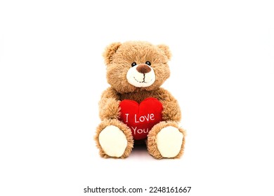 Teddy bear with red heart and text 'I love you' isolated on white background. Concept Valentine's Day.