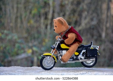 Teddy Bear Sits On Motorcycle Outside