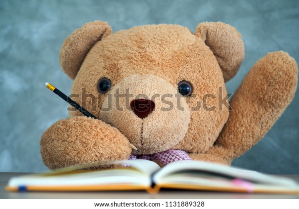 Teddy Bear Sitting On Desk Raise Stock Photo Edit Now 1131889328