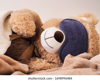 teddy bear sleeping in a blindfold