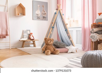 Teddy Bear And Star Pillow In Front Of Tent In Child's Room Interior With Pouf And Poster. Real Photo