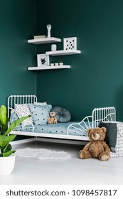 Teddy Bear Toy By A White Twin Bed In A Dark Green Room Interior For A Child With White Decor And A Plant