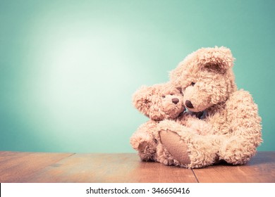 Teddy Bear toy mother with baby concept. Retro old style filtered photo