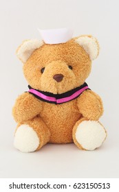 Teddy Bear Wearing A Nurse Hat On A White Background.