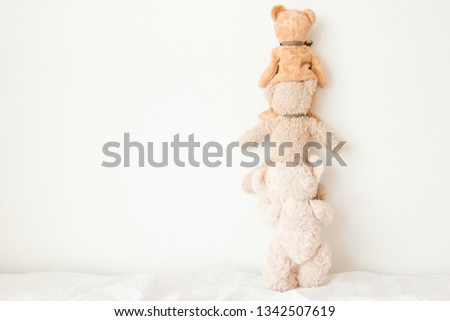 Teddy bears do a pyramid of acrobats, They are playful with a happy feel