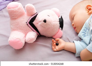 Teddy Bear's Eye Was Detached By Toddler And In Sleeping 10 Months Old Baby Hand, Poorly Attached Button Was Removed By Kid, Beware Of Choking Hazard For Children Concept, Warning For Parent