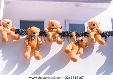 Teddy bears hanging decoration on house.