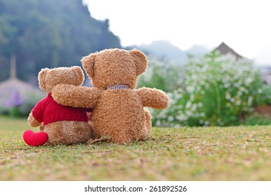 Teddy bears sitting on the beautiful garden with love. Concept about love and relationship