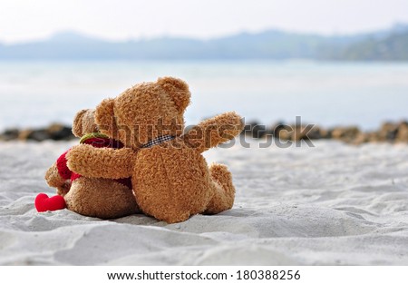 Teddy bears sitting on the beautiful beach with love. Concept about love and relationship