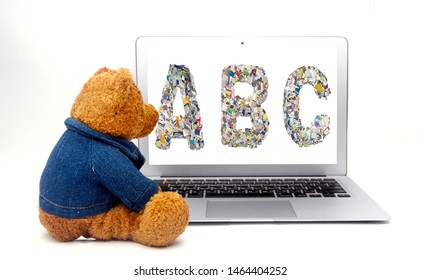teddy learns the alphabet on a laptop computer