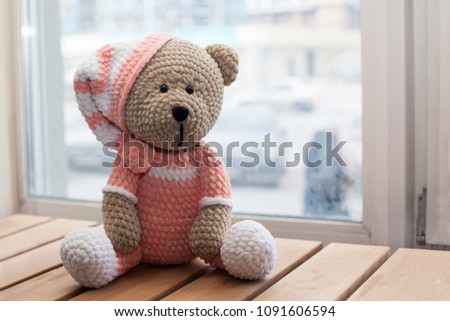 Teddybear toy knitted in the technique of knitting amigurumi.