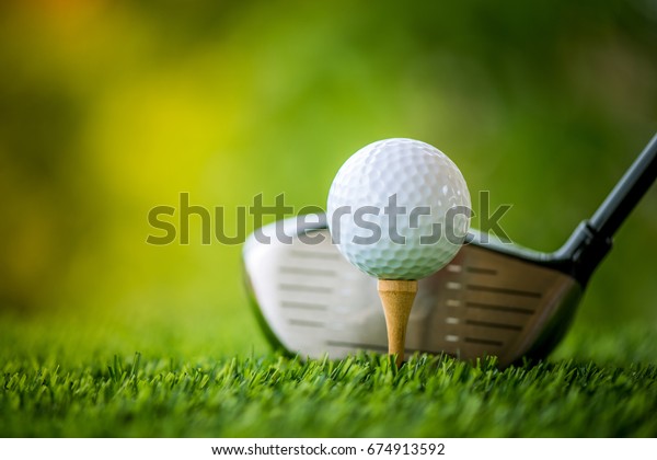 teeing off with golf\
club and golf ball