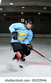 A Teen Age Hockey Player Makes Sharp Stop In The Rink