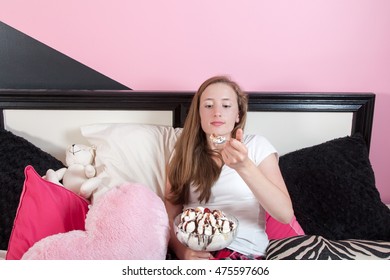 Teen Aged Girl Sitting In Her Trendy Pink Room Eating A Huge Ice Cream Sundae