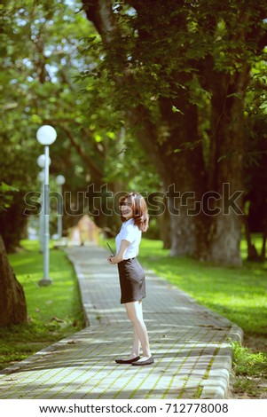 Similar – beautiful young woman smiling while walking in the park