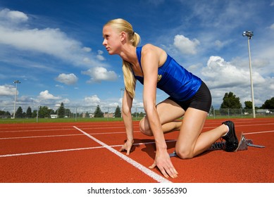 A Teen Athlete Ready To Race In The Starting Blocks