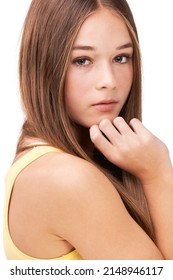 Teen Attitude. Studio Portrait Of A Teen Girl With Her Hand On Her Chin Isolated On White.