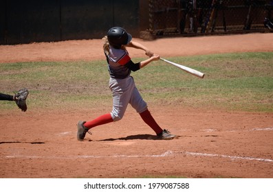 Teen Baseball Player Swinging Bat