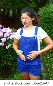 Teen Beautiful Girl With Stomach Ache On The Summer Green Garden Background