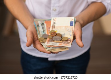 Teen Blond Boy In White Shirt Holding Money At His Hands