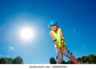 Teen Boy In Blue Helmet Skate On Rollerblades In The Skatepark Pose Looking Down To Camera