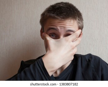 Teen Boy Covers His Face With His Hands