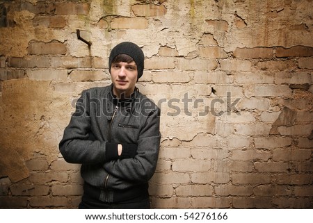 Teen boy dressed in black in an abandoned factory