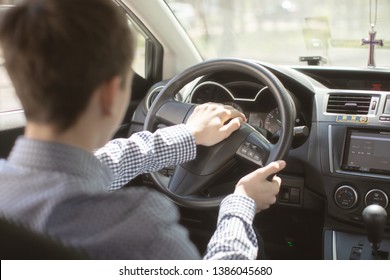 Teen Boy Driving A Car View From The Car .teen Holding Hands Behind The Wheel Of The Car
