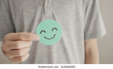 Teen Boy Hand Holding Green Happy Smile Face Paper Cut, Mental Health Assessment, Child Positive Wellness, World Mental Health Day Concept