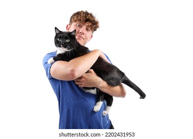 Teen Boy Holding His Black And White Tuxedo Cat