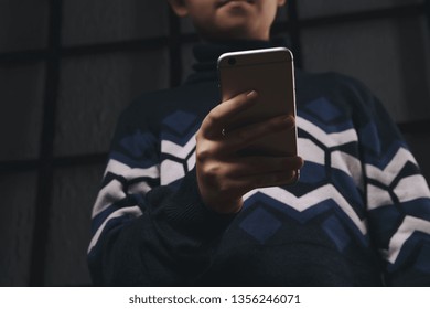 Teen Boy Holding Phone And Feeling Sad. Victim Of Cyberbullying. Phone Bullying.