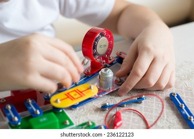 A Teen Boy At Home With Electronic Project