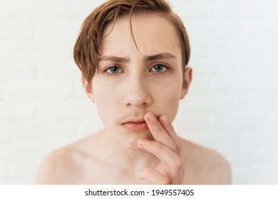 Teen boy looks at his first mustache, puberty period, early adulthood - Shutterstock ID 1949557405