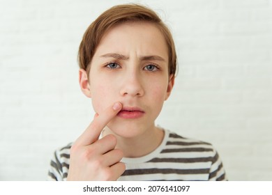 Teen boy looks at his first mustache in mirror, puberty period, early adulthood - Shutterstock ID 2076141097