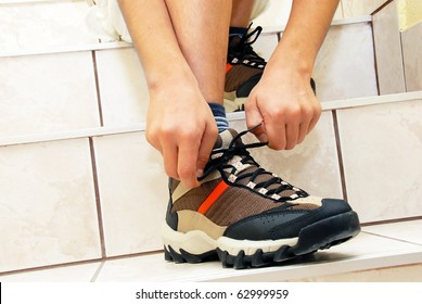 Teen Boy On Stairs Tying His Shoe Closeup