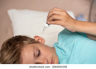 Teen Boy With Otitis And Earaches Holding Drops For Treatment. Kid Suffering From Otitis. Acute Ear Pain,
Inflammatory Disease Of The Middle Ear