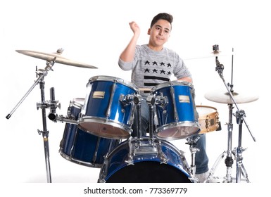 Teen Boy Plays The Drums In Studio Against White Background