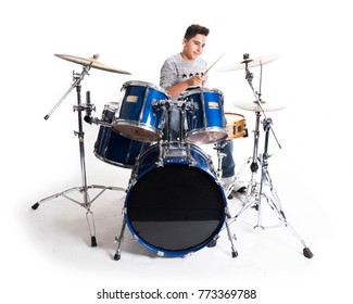 Teen Boy Plays The Drums In Studio Against White Background