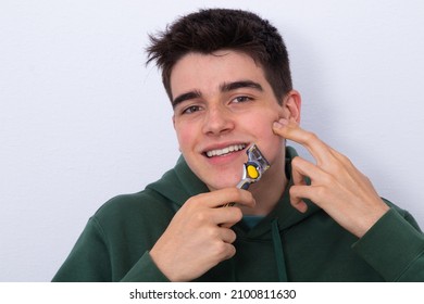 Teen Boy With Razor On White Background