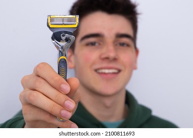 Teen Boy With Razor On White Background