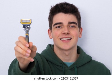 Teen Boy With Razor On White Background